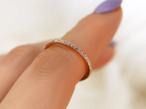 Close-up of a hand wearing a diamond ring on a blurred background
