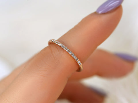 Close-up of a hand wearing a diamond ring with a blurred background
