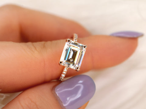 east west set emerald cut solitaire with diamonds on band on pointer