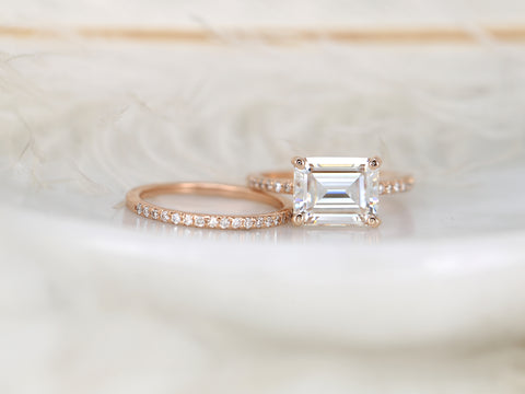 east west set emerald cut solitaire with diamonds on shank and matching diamond band on white background front