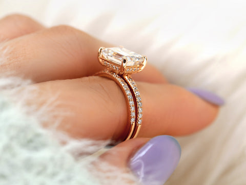 east west set emerald cut solitaire with diamonds on shank and matching diamond band on pointer finger