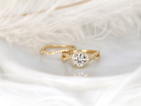 14kt gold bridal set with round moissanite center and delicate crossover diamond-accented band on soft background