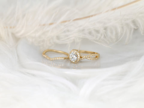 14kt gold bridal set featuring a round halo moissanite center and diamond-accented crossover bands on soft white feathers