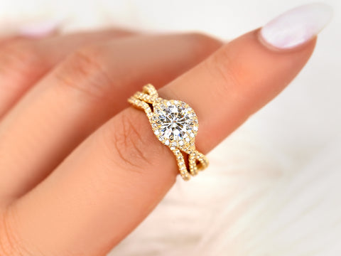 14kt gold moissanite bridal set with round halo and distinctive crossover band shown on finger
