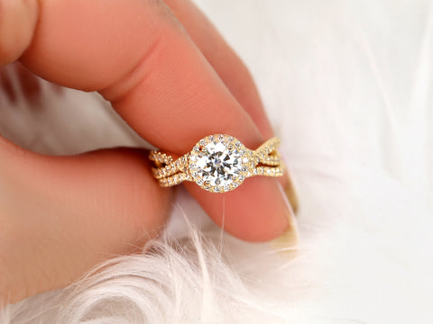 14kt gold moissanite bridal set with round halo and crossover bands shown on a soft white background