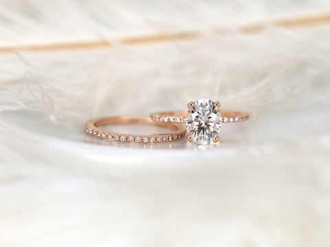 2ct oval moissanite solitaire with accents wedding ring set on white background