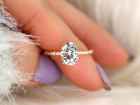 oval solitaire with diamond accents on pointer finger