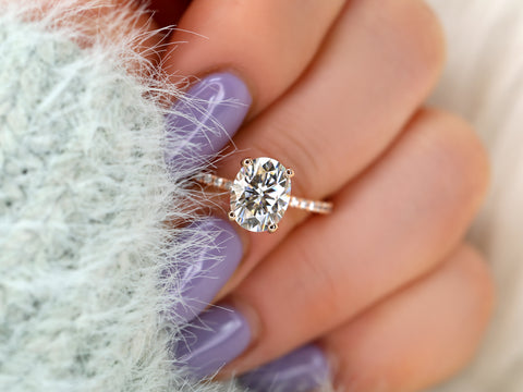 oval solitaire with diamond accents on middle finger