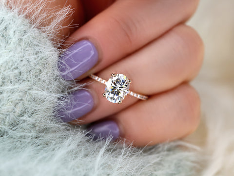 oval solitaire with diamond accents on ring finger
