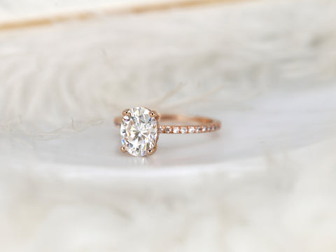 oval solitaire with diamond accents on white background angle
