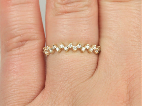 Close-up of a delicate 14kt gold diamond halfway eternity ring worn on a finger with natural skin texture