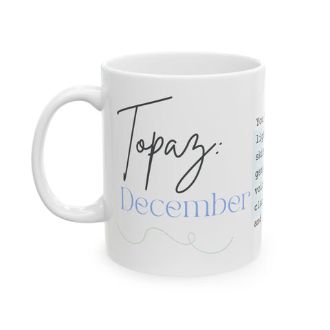 White ceramic mug with "Topaz December" text in black and blue script on side view