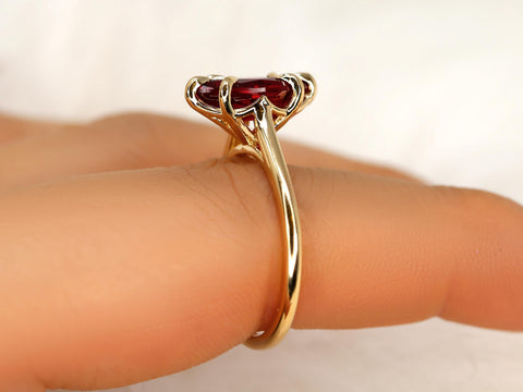 Close-up of slender 14kt gold ring featuring a marquise ruby solitaire with delicate prong details on finger