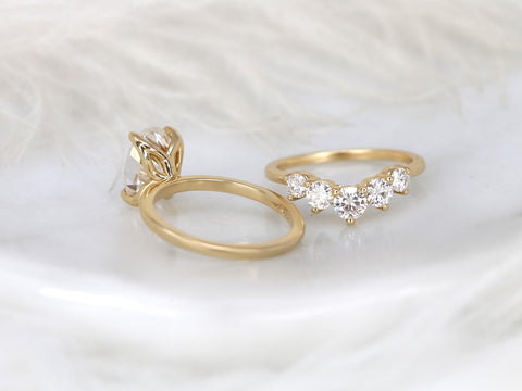 Elegant 14kt gold bridal set featuring an oval solitaire moissanite and a curved band with sparkling stones