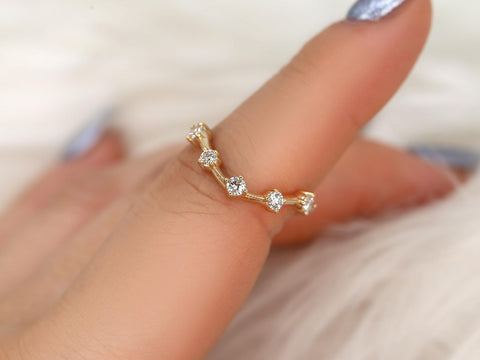 Delicate 14kt gold ring with five small round diamonds arranged in a dainty, modern linked design on finger
