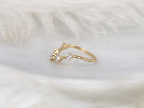 Delicate 14kt gold ring with three small diamond stones in a graceful curved design on soft white backdrop