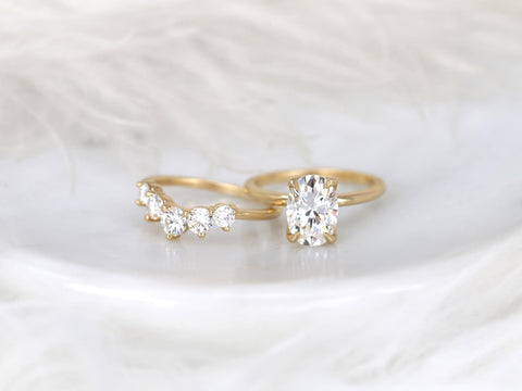 14kt gold bridal set featuring a 2.50ct oval moissanite solitaire and curved band with round stones