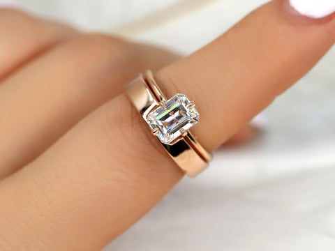 14kt gold bridal set featuring an emerald cut solitaire moissanite on a matching wedding band
