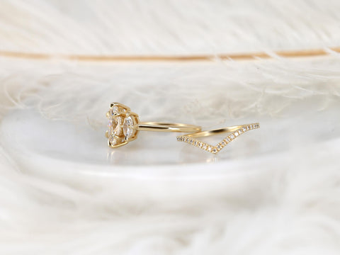 14kt gold bridal set with marquise moissanite center and curved diamond-accented wedding band on soft background