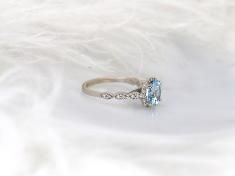 Delicate ring with an 8mm aquamarine center and diamond milgrain cushion halo on a finely detailed gold band.
