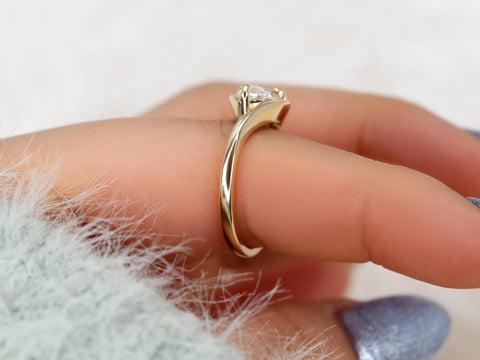 Delicate gold band with a horizontally set marquise diamond solitaire ring, ideal for an elegant engagement gift