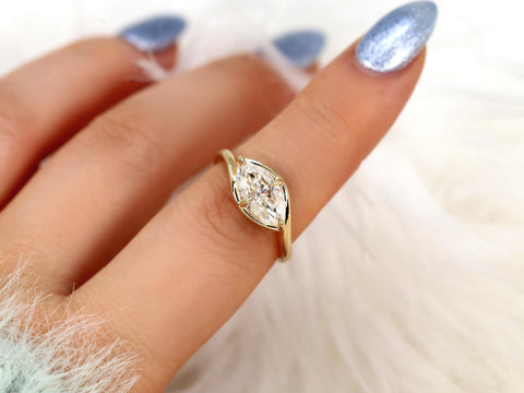 Hand wearing a sleek gold ring with a horizontally set marquise diamond, perfect for fine jewelry or engagement gift.