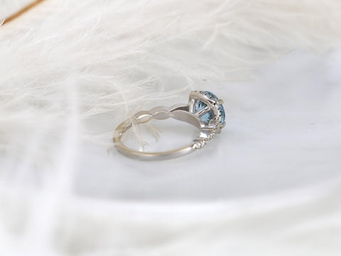 Delicate 14kt white gold ring featuring an aquamarine center stone with a milgrain diamond halo on a decorative band