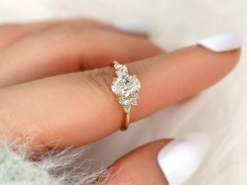 Gold ring with a diamond on a finger against a blurred background