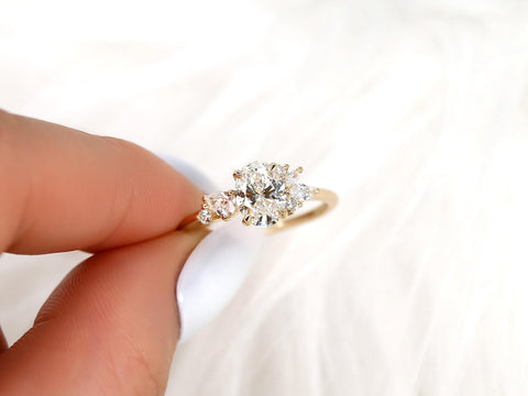 Gold ring with a diamond held by a hand on a white background
