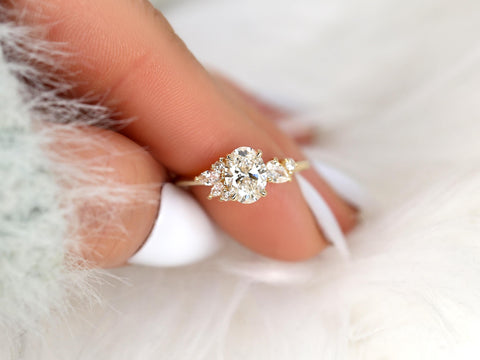 Gold ring with a diamond on a finger against a soft background