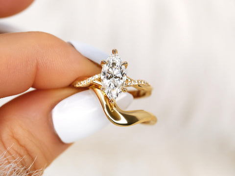 1.50ct Petite Tula 12x6mm & Merida 14kt Diamond Crossover Marquise Bridal Set pinched between fingers
