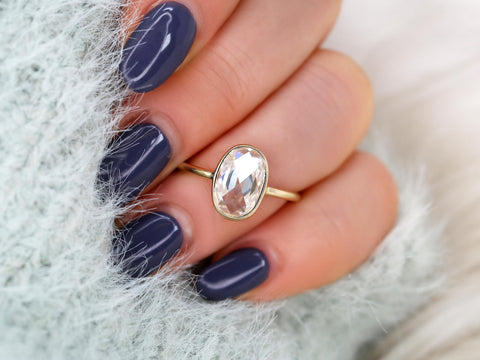 oval rose cut ring on middle finger in yellow gold