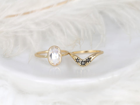 moissanite rose cut oval ring paired with a three diamond celestial curved band in gold on white background