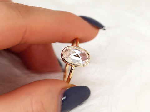oval rose cut ring on between two fingers in yellow gold