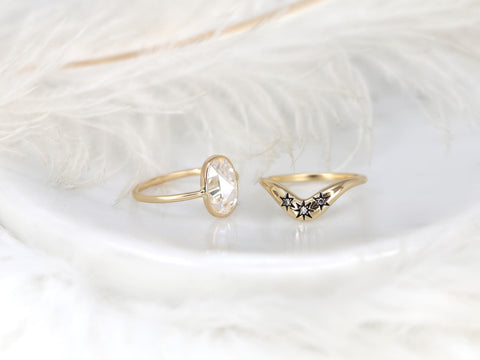 moissanite rose cut oval ring paired with a three diamond celestial curved band in gold on white background sideview