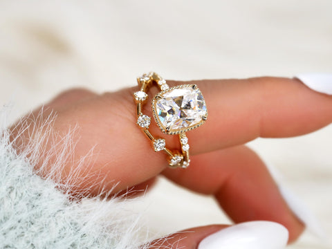 antique cushion engagement ring with button back paired with a curved diamond spaced band on pointer finger
