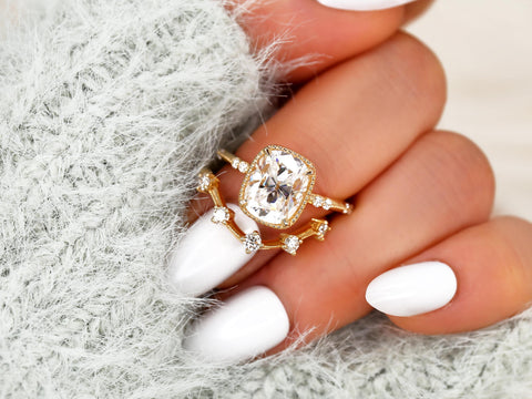 antique cushion engagement ring with button back paired with a curved diamond spaced band on middle finger