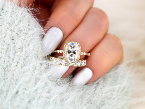 antique cushion cut button back ring with accent diamonds paired with a thick diamond band on ring finger