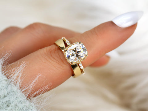 antique cushion solitaire with button back, claw prongs, and diamond accents on band. the ring is paired with a chevron solid gold band worn on a pointer finger