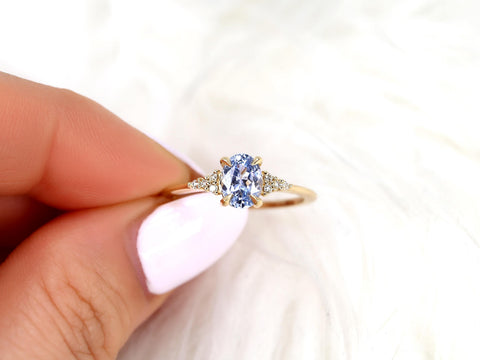oval cornflower lilac sapphire cluster ring with dainty diamonds pinched between fingers