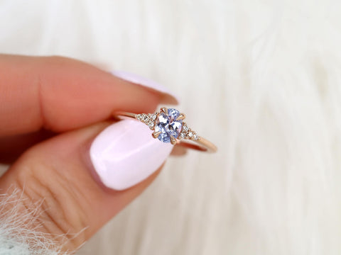oval cluster sapphire ring with lavender sapphire in rose gold held by two fingers