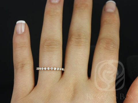 Delicate rose gold ring featuring small sparkling diamonds in a nearly full eternity band on a hand