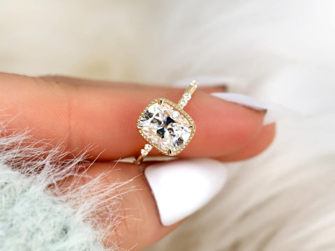 antique cut cushion button back solitaire with diamond accents front view between finger white background
