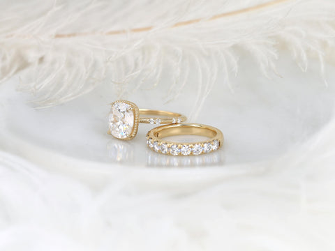 antique cushion cut button back ring with accent diamonds paired with a thick diamond band shown on angle on white background