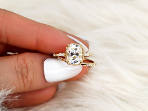 antique cushion button back ring with milgrain edge paired with a open diamond band with pointed opening shown pinched between fingers