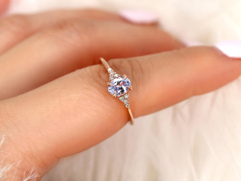 oval cluster sapphire ring with lavender sapphire in rose gold held on pointer finger