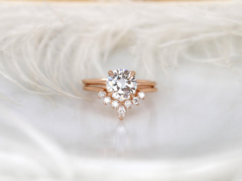 round engagement wedding ring set in rose gold with a complimentary unique curved ring on white background