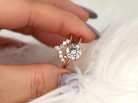 round solitaire moissanite paired with a unique diamond nesting band in 14kt rose gold between fingers