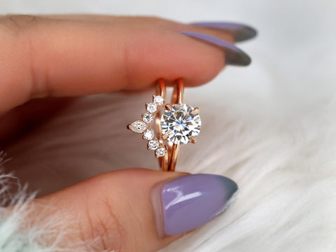 round solitaire moissanite paired with a unique diamond nesting band in 14kt ring with purple nails