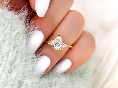 pear cut diamond ring with cluster diamonds on a ring finger
